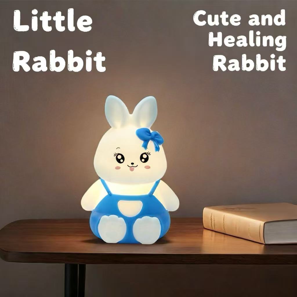 Blue bunny night light glowing on bedside table