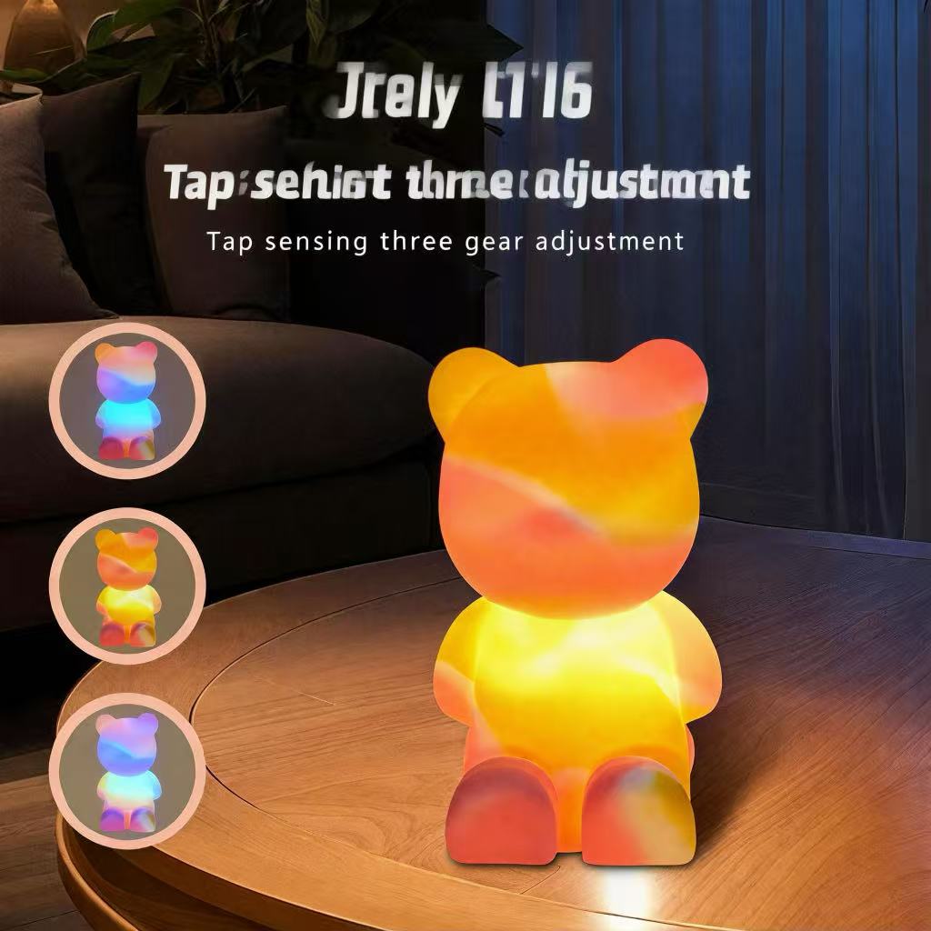 Bear silicone lamp showing colorful lighting modes in a dark living room