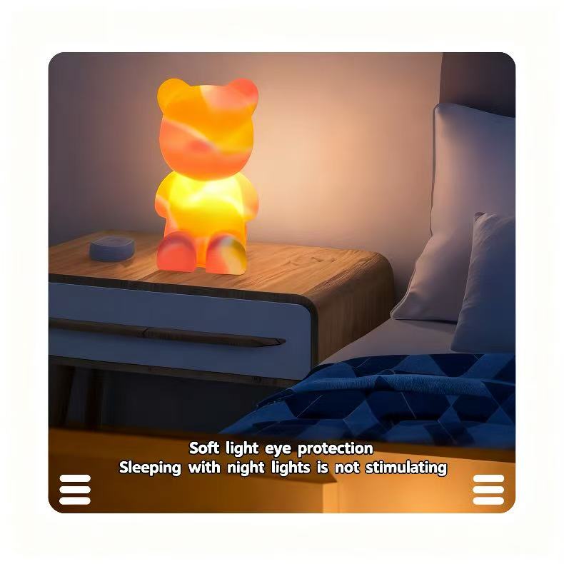 Bear night light glowing on a bedside table