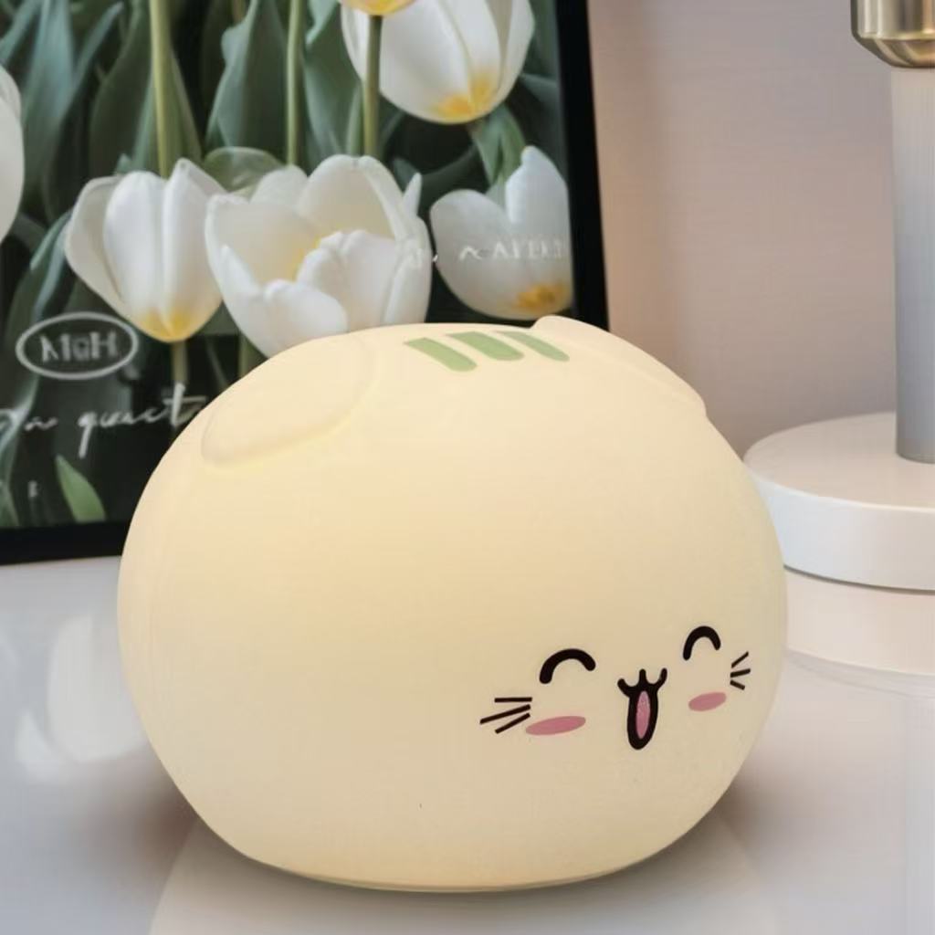 Warm glow cat night light on bedside table